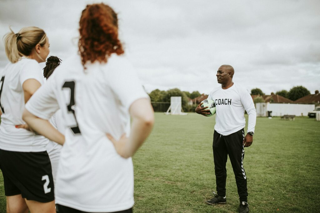 Female football players listening to the coach